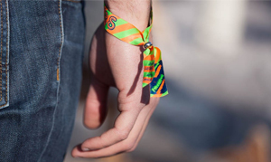 Personne portant au poignet un bracelet en tissu personnalisé.